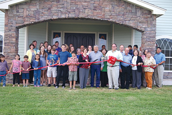 The congregation of the Community of Christ Church gather to cut the ribbon