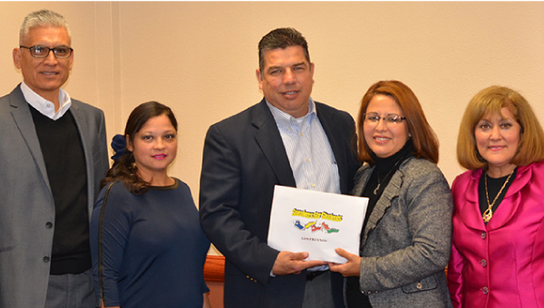 LFCISD Superintendent Gonzalo Salazar accepts the vouchers from Gloria Ricones, President of theWomen’s Law Section of the Cameron County Bar.