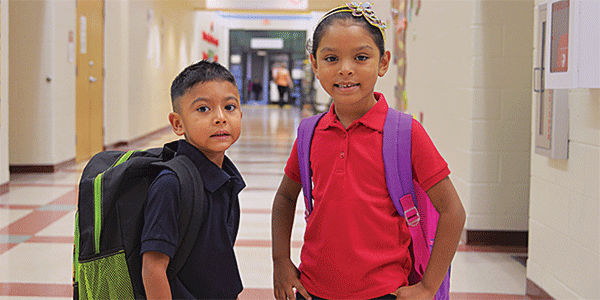 Above: Los Fresnos Elementary students are ready for first day of class. Left: District buses departed on schedule to pick up students for the first day of class Monday. Photo: LFCISD.net 