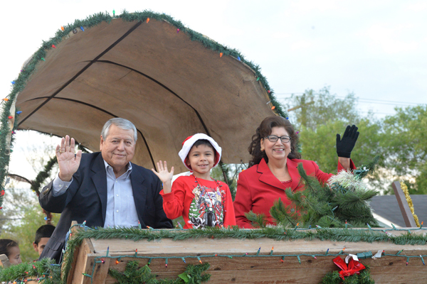 Mayor Polo Narvaez, along with his grandson and wife Carlotta Narvaez, wave to the gathered crowd at this year’s Christmas Parade. Photos: LFCISD Flickr (flickr.com/photos/losfresnos/sets/)