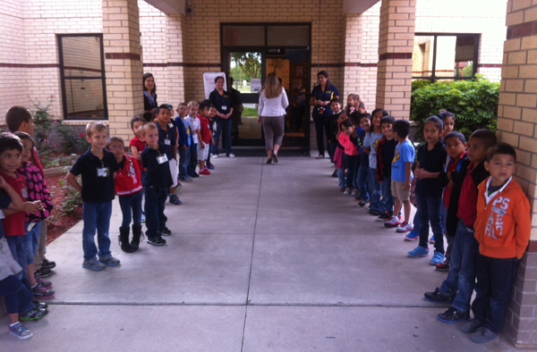 PLE students welcome visitors with smiles and big "hello's"