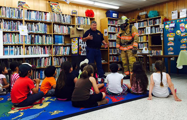 Fire Marshall and Assistant Chief, Geronimo Sheldon and Assistant Chief, Walley Bennett speak to children about fire safety at Ethel Whipple Memorial Library. Photo: The Ethel Whipple Memorial Library/Facebook.