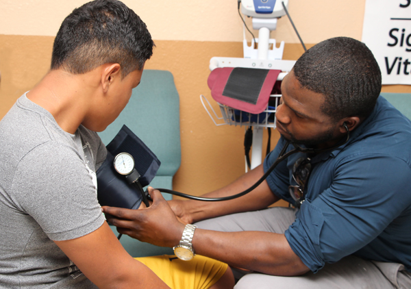 UTRGV medical resident Dr. Charles Lewis checked blood pressure for residents of the Indian Hills colonia during a STITCH health care fair. (UTRGV Photo)