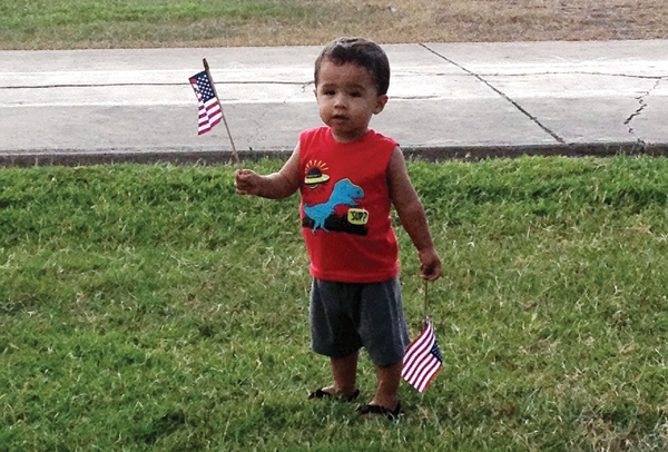 A small child waves the American Flag at the 2014 4th of July celebration. LFN Stock Photo