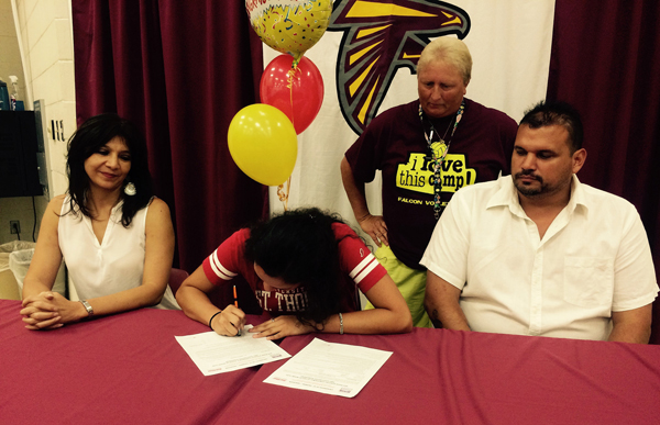 Alex Cano signs her national letter of intent to play volleyball for the Univeristy of St. Thomas as her parents and Los Fresnos head volleyball coach Becky Woods look on. Photo:LFCISD