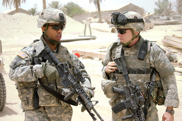 An African American soldier and white soldier working together. Photo: Rockfinder.