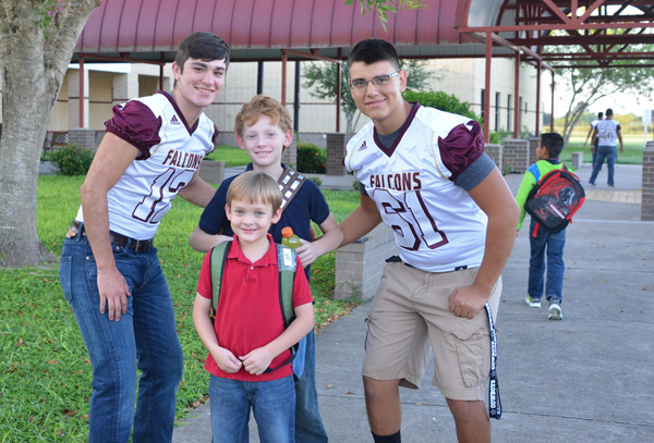 LFHS Falcon football players greet students arriving at Palmer-Laakso Elementary School.