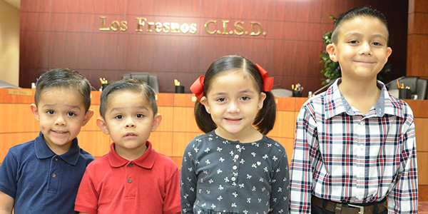 Leading the Pledge of Allegiance before the meeting were students (left to right) Ronaldo and Romario Barreto, pre-kindergarten students at Lopez-Riggins Elementary; and Katelynn and Ethan Ozuna, students at Los Fresnos Elementary.