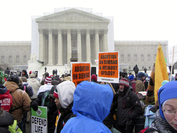 Pro-choice and anti-abortion advocates gathered in front of the U.S. Supreme Court Wednesday as the justices heard oral arguments on a law that restricts abortions in Texas. Photo: TNS
