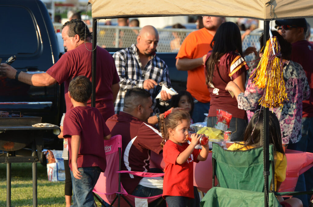 Los Fresnos Falcons fans barbecueing while school students perform at last year’s Tailgate Zone. Photo: LFCISD